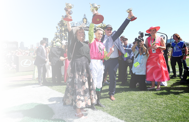 MELBOURNE, AUSTRALIA - NOVEMBER 05: Robbie Dolan poses with trainers Sheila Laxon and John Symons and the cups after Knight's Choice won Race 7, the Lexus Melbourne Cup - Betting Odds during Melbourne Cup Day at Flemington Racecourse on November 05, 2024 in Melbourne, Australia. (Photo by Josh Chadwick/Getty Images)